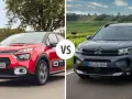 Dwa modele Citroen SUV: czerwony i ciemnoszary, jadące po drodze.