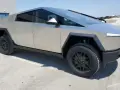 Futurystyczny Tesla Cybertruck na betonowym placu. Zastanawiasz się nad jego tesla cybertruck cena?