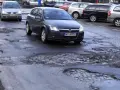Samochody jadą po dziurawej drodze. Czy warto wykupić ubezpieczenie Europa Ubezpieczenia opinie?