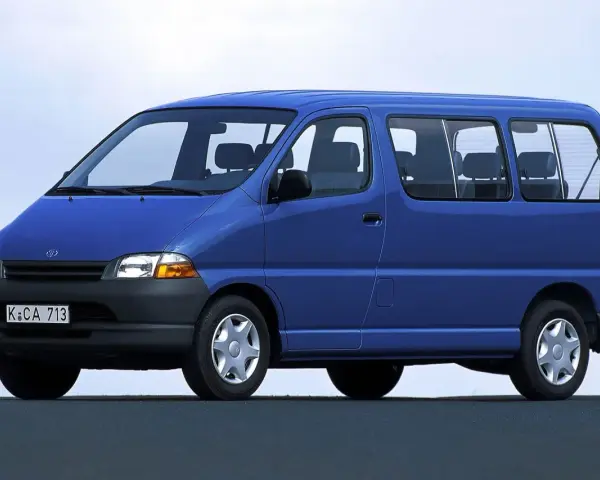 Niebieski van Toyota Hiace z lat 90. z widocznymi siedzeniami i oknami.
