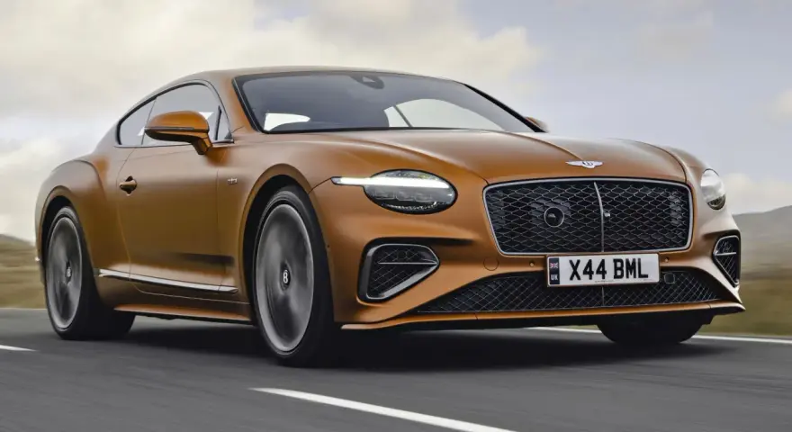 Pomarańczowy Bentley Continental GT na drodze. Sprawdź aktualną bentley cena i poczuj moc.