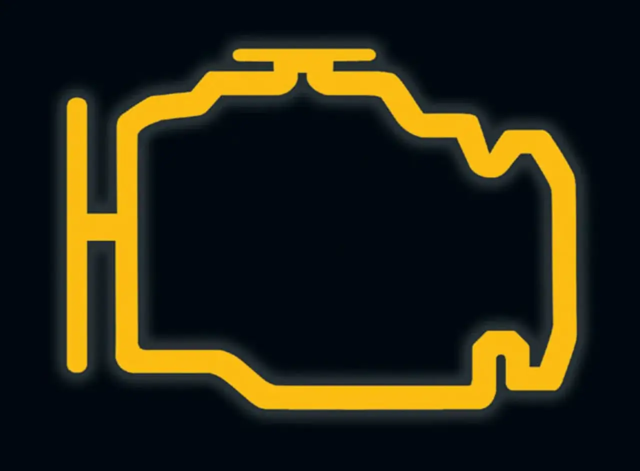 Żółty symbol silnika na ciemnym tle. To znak, że należy sprawdzić check engine.